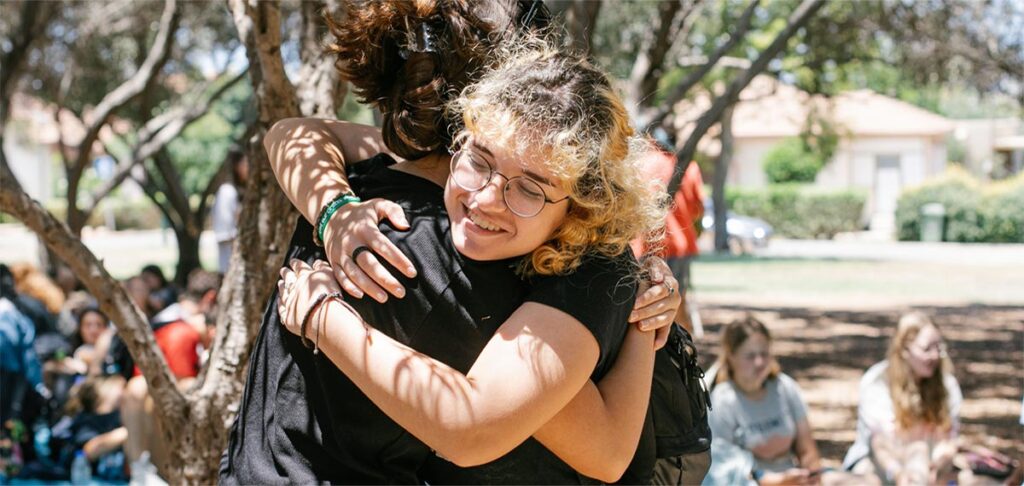 Two teens hugging at RootOne a life-changing summer experience in Israel