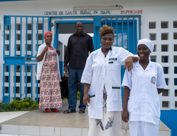 Staff in front of the Diape Clinic in Côte d’Ivoire. Image Courtesy of Muso.